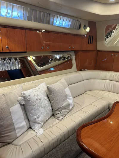  Yacht Photos Pics Luxurious interior of 2001 Sea Ray 410 Express Cruiser with plush seating and elegant wood finishes.