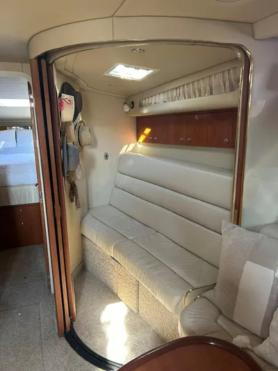  Yacht Photos Pics Interior of 2001 Sea Ray 410 Express Cruiser with cream leather seating and wooden cabinets.