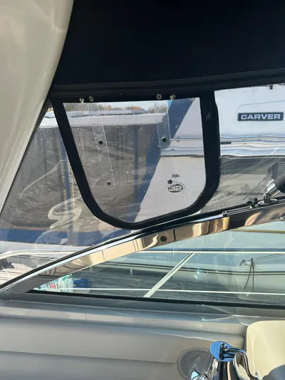  Yacht Photos Pics 2001 Sea Ray 410 Express Cruiser window detail with marina background.