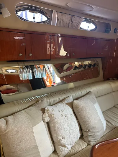  Yacht Photos Pics Luxurious interior of a 2001 Sea Ray 410 Express Cruiser with plush seating and elegant cabinetry.