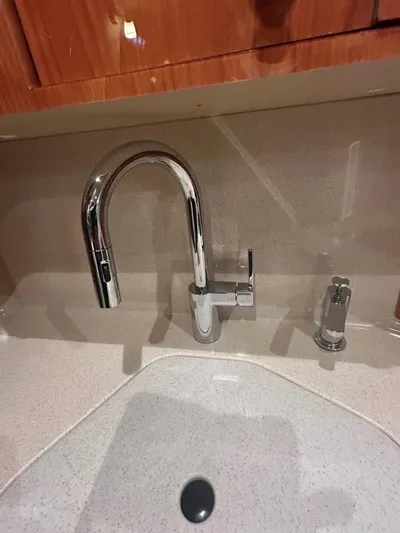  Yacht Photos Pics Chrome faucet and sink in 2001 Sea Ray 410 Express Cruiser kitchen.