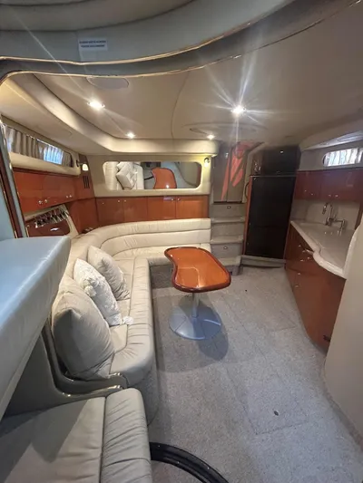  Yacht Photos Pics Luxurious interior of 2001 Sea Ray 410 Express Cruiser with elegant seating and wooden table.