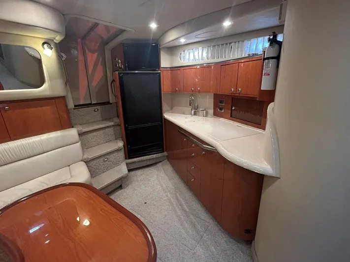  Yacht Photos Pics Interior of 2001 Sea Ray 410 Express Cruiser with kitchen and seating area.