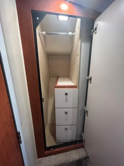  Yacht Photos Pics Interior closet of 2001 Sea Ray 410 Express Cruiser with drawers and hanging rod.