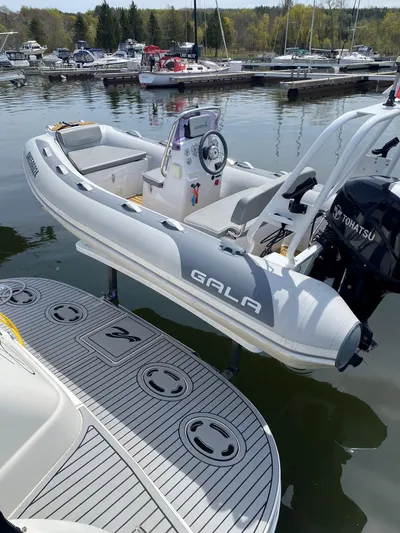  Yacht Photos Pics A Gala inflatable boat with Tohatsu motor docked near a 2001 Sea Ray 410 Express Cruiser.