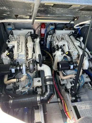  Yacht Photos Pics Engine room of 2001 Sea Ray 410 Express Cruiser with dual engines and fire extinguisher.