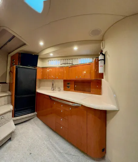  Yacht Photos Pics Interior of 2001 Sea Ray 410 Express Cruiser with modern kitchen and wooden cabinetry.