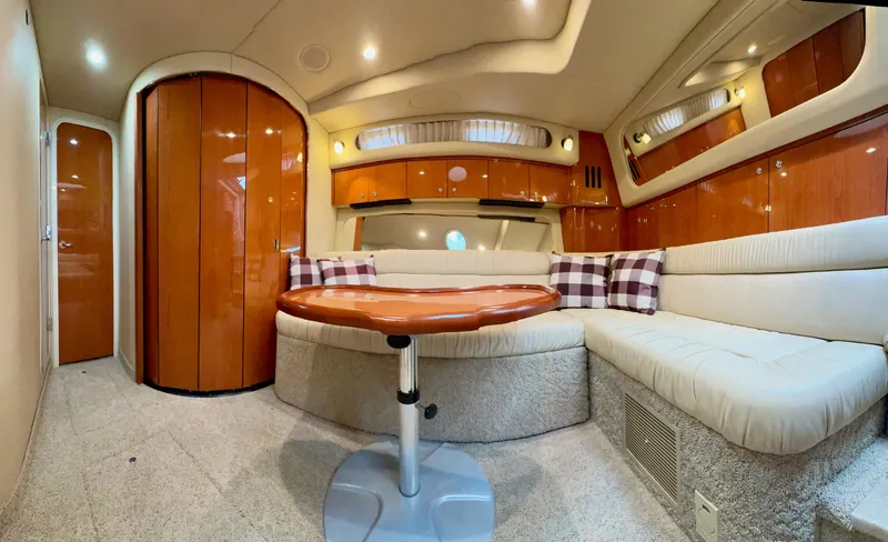  Yacht Photos Pics Luxurious interior of a 2001 Sea Ray 410 Express Cruiser with plush seating and wooden accents.