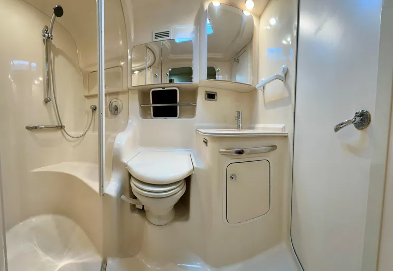  Yacht Photos Pics Bathroom interior of 2001 Sea Ray 410 Express Cruiser with shower, toilet, and sink.