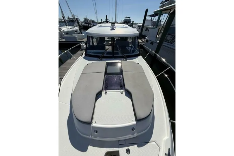 Zoom Away Yacht Photos Pics 2020 Jeanneau NC 1095 boat docked, featuring sleek design and spacious deck.