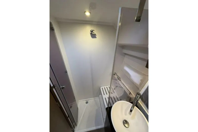 Zoom Away Yacht Photos Pics Bathroom interior of 2020 Jeanneau NC 1095 boat, featuring modern sink and shower.