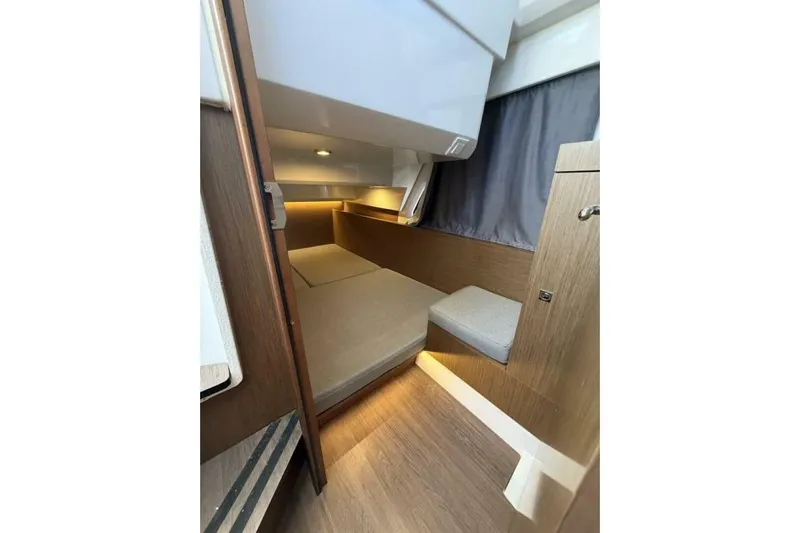 Zoom Away Yacht Photos Pics 2020 Jeanneau NC 1095 cabin interior with wood finish and cozy lighting.