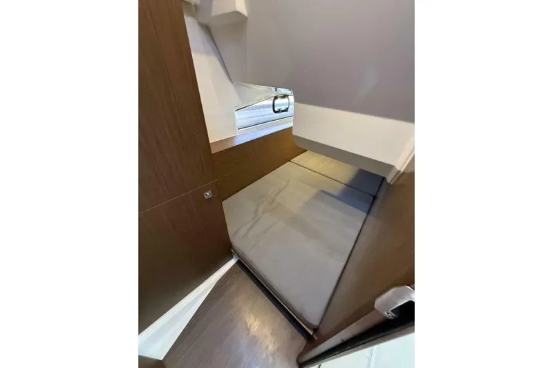 Zoom Away Yacht Photos Pics 2020 Jeanneau NC 1095 cabin interior with compact bed and window view.