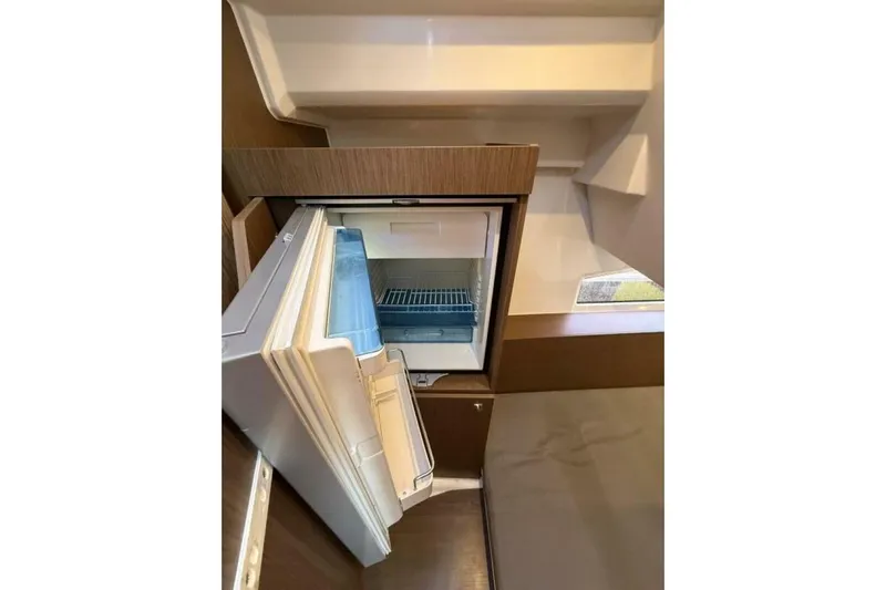 Zoom Away Yacht Photos Pics Interior view of 2020 Jeanneau NC 1095 boat with open refrigerator.