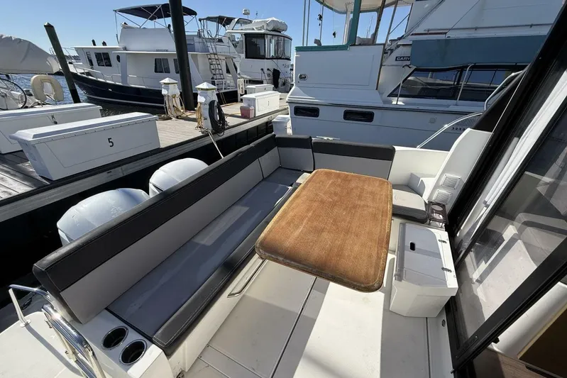 Zoom Away Yacht Photos Pics 2020 Jeanneau NC 1095 boat with spacious seating and table at the dock.