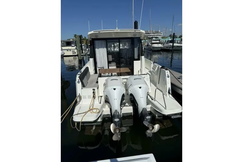 Zoom Away Yacht Photos Pics 2020 Jeanneau NC 1095 boat with dual outboard motors docked at marina.