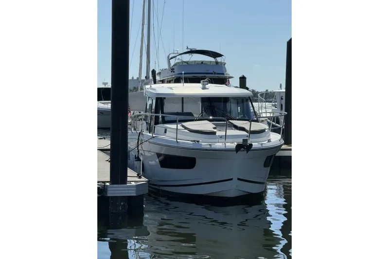Zoom Away Yacht Photos Pics 2020 Jeanneau NC 1095 boat docked at marina, front view.