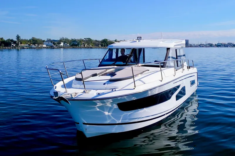 Zoom Away Yacht Photos Pics 2020 Jeanneau NC 1095 boat cruising on calm blue waters.