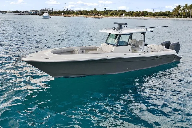 Onyx Yacht Photos Pics 2023 HCB 39 Speciale boat on clear blue water near a tropical shoreline.