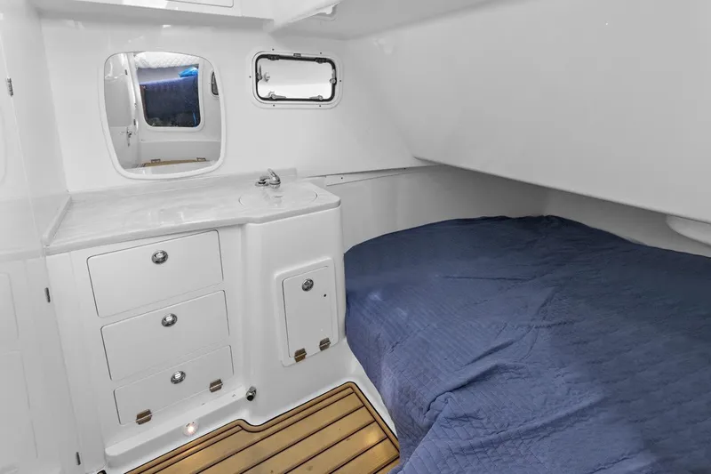 Onyx Yacht Photos Pics 2023 HCB 39 Speciale cabin interior with bed, sink, and storage drawers.