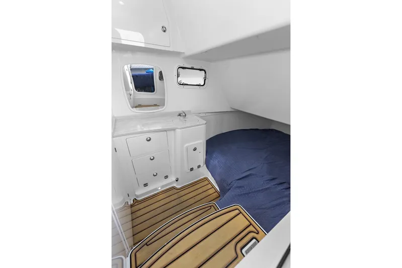 Onyx Yacht Photos Pics 2023 HCB 39 Speciale cabin interior with bed, sink, and wooden flooring.