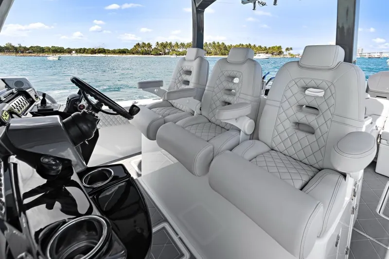 Onyx Yacht Photos Pics Luxurious interior of 2023 HCB 39 Speciale boat with plush seating and scenic ocean view.