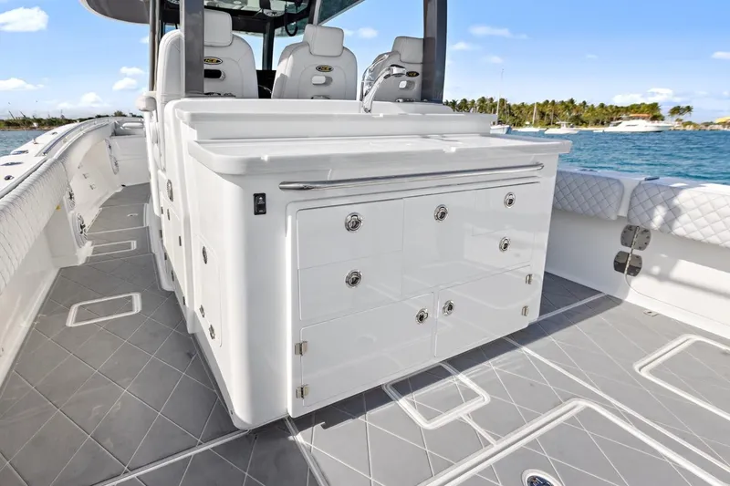 Onyx Yacht Photos Pics 2023 HCB 39 Speciale boat interior with sleek cabinetry and seating, docked by the water.