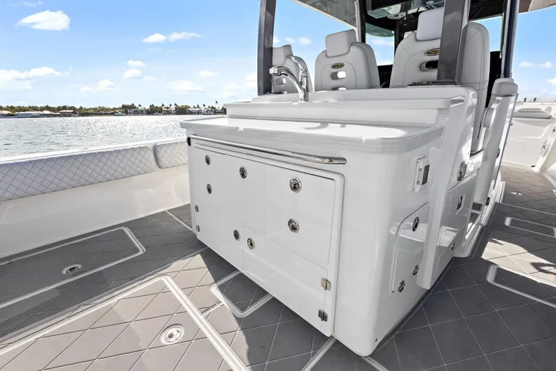 Onyx Yacht Photos Pics 2023 HCB 39 Speciale boat interior with sleek cabinetry and seating, overlooking serene waters.