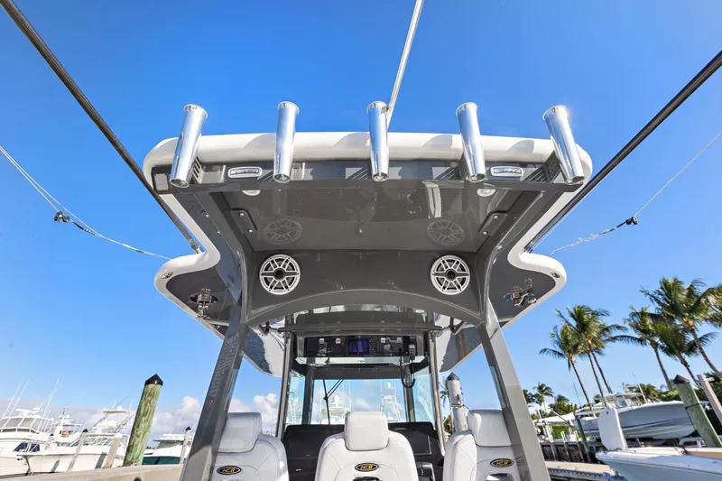 Onyx Yacht Photos Pics 2023 HCB 39 Speciale boat with rod holders and speakers, docked under clear blue sky.