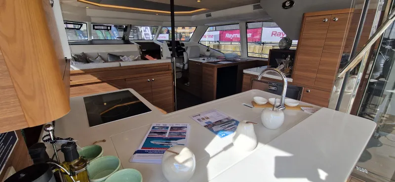  Yacht Photos Pics Interior of 2024 Aquila 44 Yacht with modern kitchen and seating area.