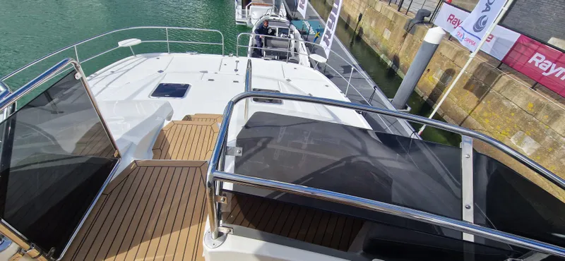  Yacht Photos Pics 2024 Aquila 44 Yacht deck with sleek design and wooden flooring.