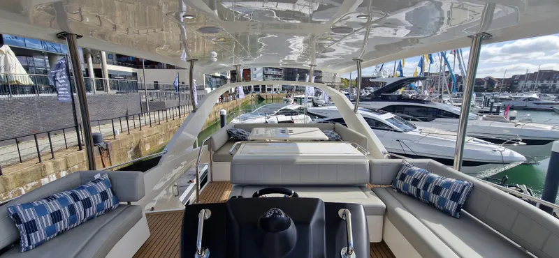  Yacht Photos Pics 2024 Aquila 44 Yacht interior with luxurious seating and marina view.