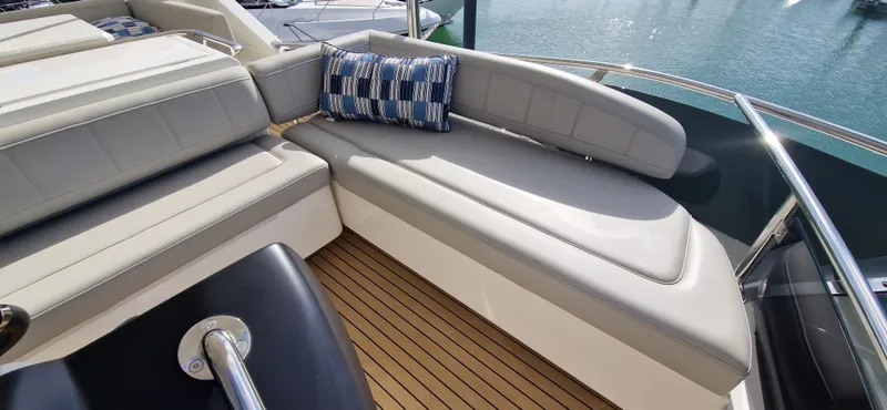  Yacht Photos Pics Luxurious seating area on 2024 Aquila 44 Yacht with elegant cushions and teak flooring.