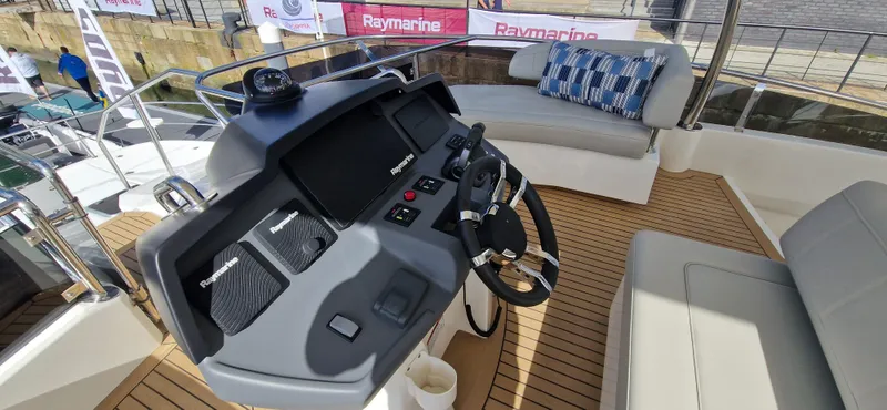  Yacht Photos Pics 2024 Aquila 44 Yacht helm with modern controls and comfortable seating.