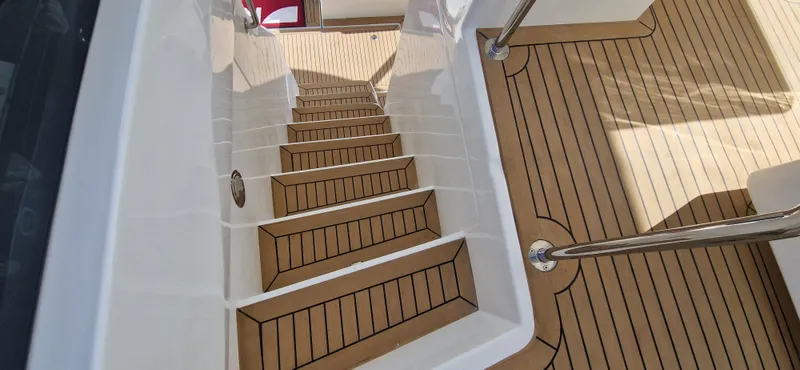  Yacht Photos Pics Staircase on 2024 Aquila 44 Yacht with teak decking and stainless steel handrails.