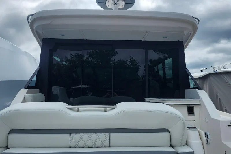  Yacht Photos Pics 2026 Regal 36 XO yacht with sleek design and luxurious seating under cloudy skies.