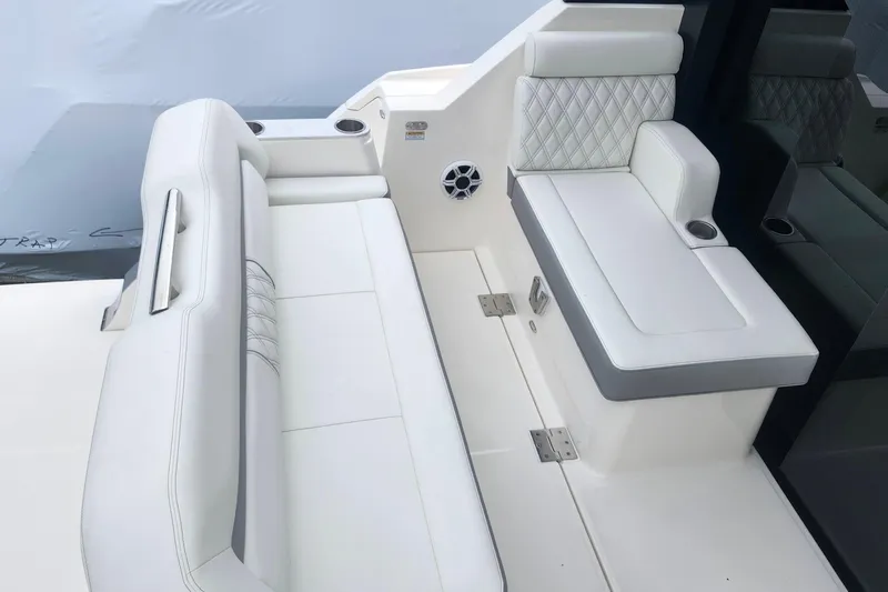  Yacht Photos Pics Luxurious seating on 2026 Regal 36 XO boat with white upholstery and cup holders.