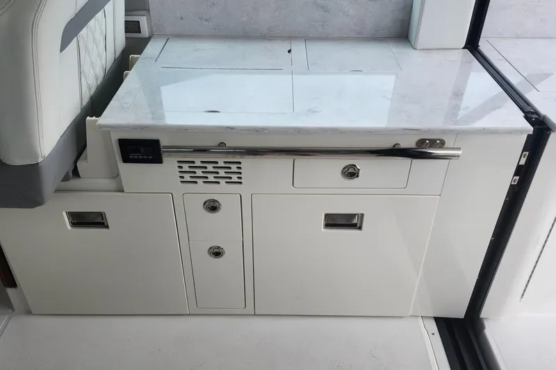  Yacht Photos Pics Modern kitchen area on 2026 Regal 36 XO yacht with sleek white cabinetry.