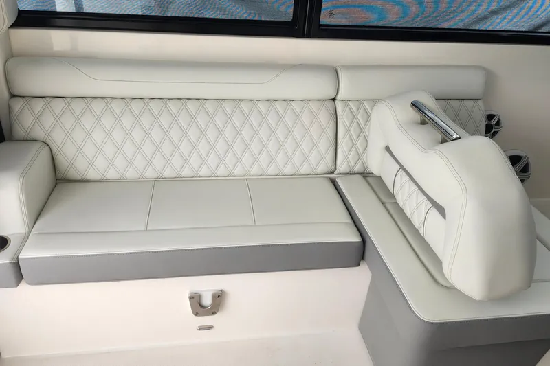  Yacht Photos Pics Luxurious white seating on 2026 Regal 36 XO boat, featuring diamond-patterned upholstery.