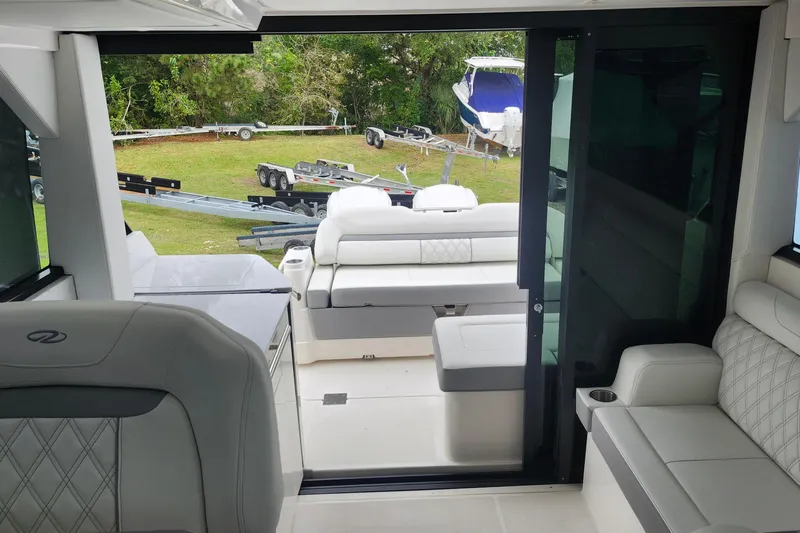  Yacht Photos Pics Interior view of 2026 Regal 36 XO yacht with luxurious seating and outdoor access.