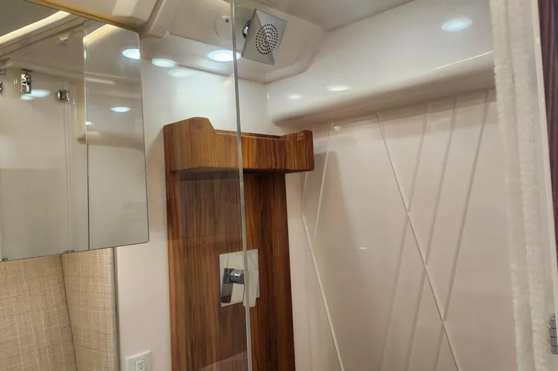  Yacht Photos Pics Luxurious bathroom interior of 2026 Regal 36 XO yacht with modern shower design.