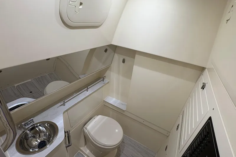  Yacht Photos Pics 2026 Scout 288 LXF boat interior bathroom with sink, toilet, and mirror.