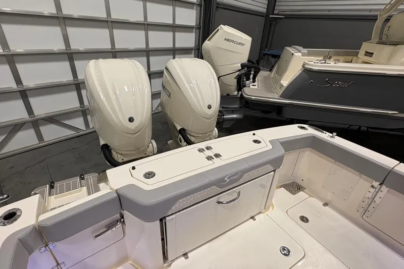  Yacht Photos Pics 2026 Scout 288 LXF boat with dual outboard engines in a garage setting.