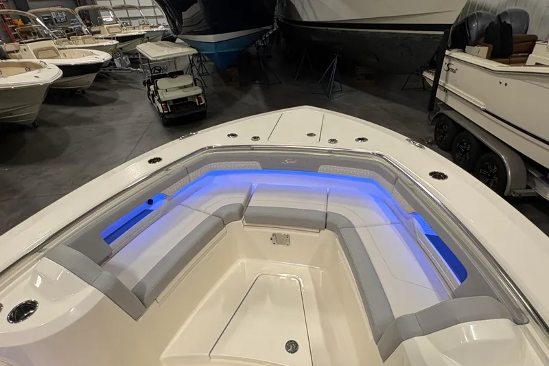  Yacht Photos Pics 2026 Scout 288 LXF boat interior with blue LED lighting and cushioned seating.
