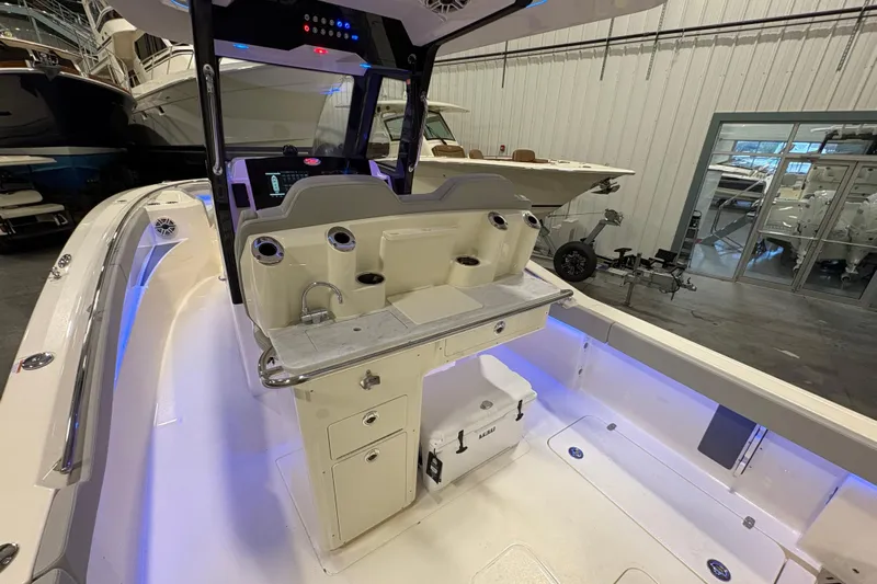  Yacht Photos Pics 2026 Scout 288 LXF boat interior with modern helm and seating in a showroom.