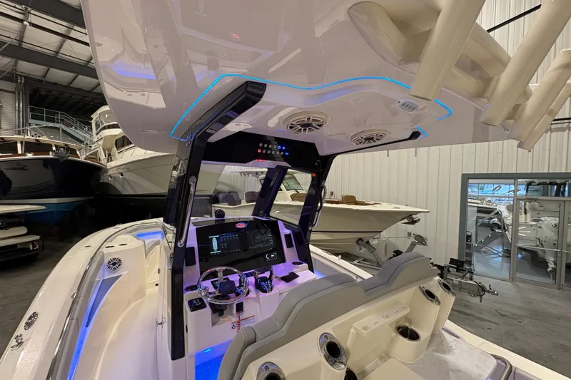  Yacht Photos Pics 2026 Scout 288 LXF boat interior with advanced dashboard and seating in a showroom.