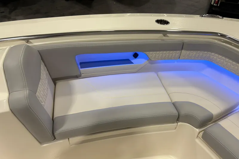  Yacht Photos Pics 2026 Scout 288 LXF boat interior with cushioned seating and ambient blue lighting.