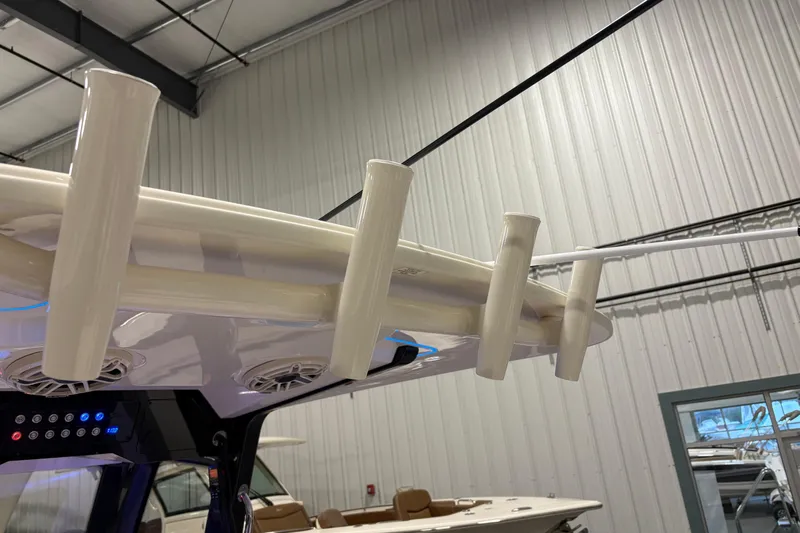  Yacht Photos Pics 2026 Scout 288 LXF boat interior with rod holders and speakers in a showroom.