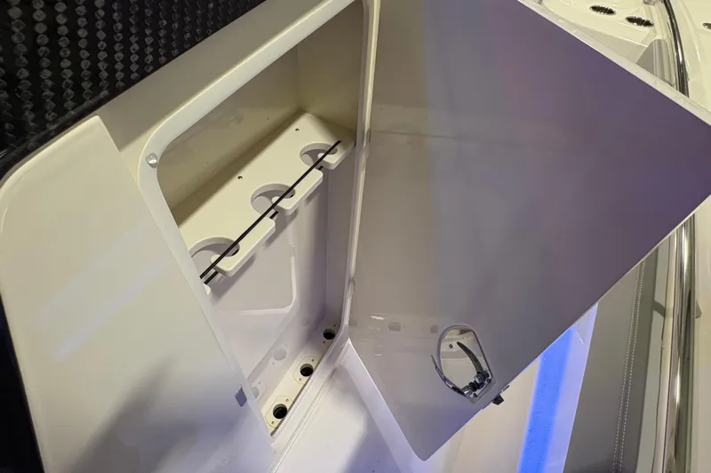  Yacht Photos Pics Open storage compartment on 2026 Scout 288 LXF boat, featuring cup holders and sleek design.
