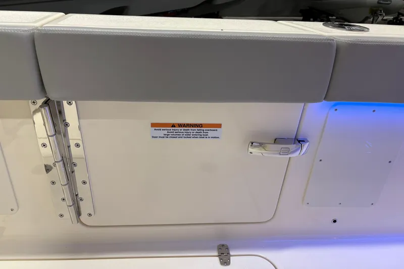  Yacht Photos Pics 2026 Scout 288 LXF boat door with warning label and secure handle.